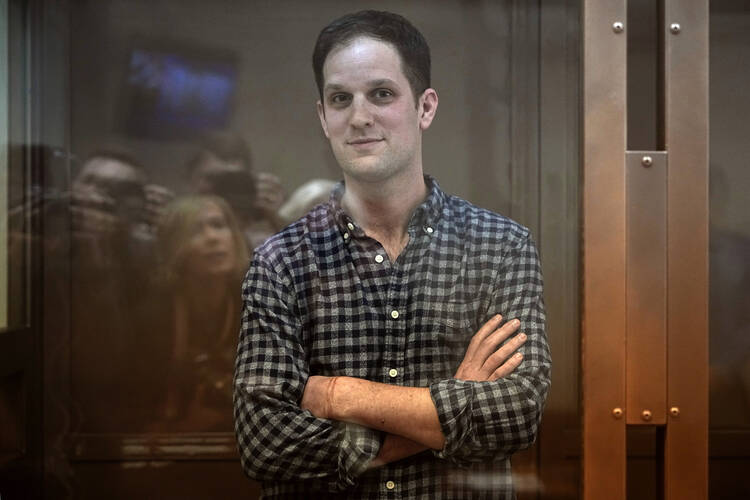 Wall Street Journal reporter Evan Gershkovich stands in a glass cage in a courtroom at the Moscow City Court, in Moscow, Russia, April 18, 2023. 