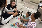 Volunteers and residents at play at Room at the Inn